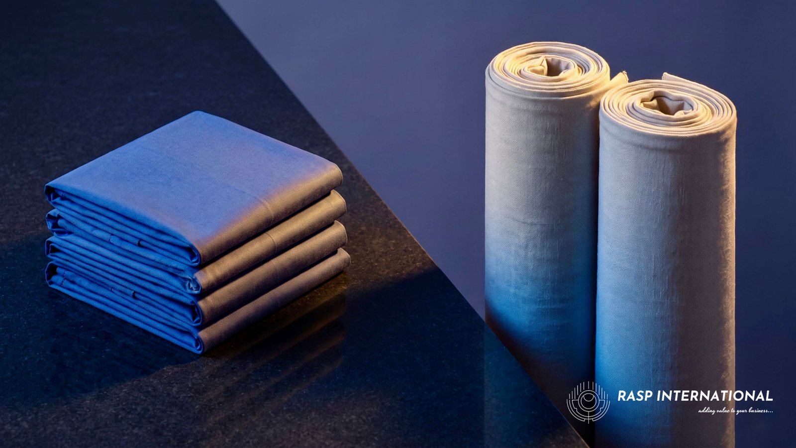 Folded finished garments beside rolls of unbleached greige cotton fabric, showing the RoSCTL and RoDTEP split for textile exporters