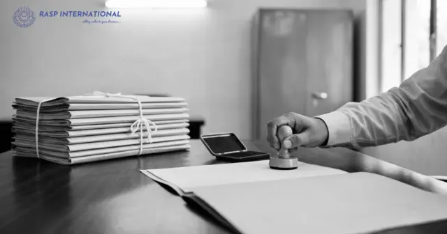 Official stamping a file on a government office table beside bundles of tied files